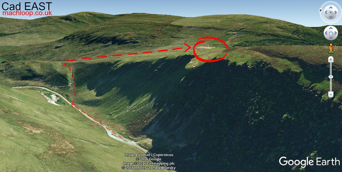 Topside view from Cad East Mach Loop viewpoint with a military aircraft visible below and Snowdonia mountains stretching to the horizon